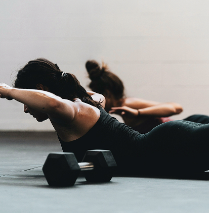 People doing floor workouts with weights.