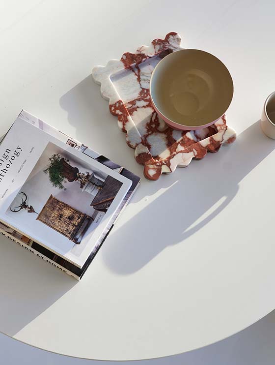 Round table with photo books and bowls.