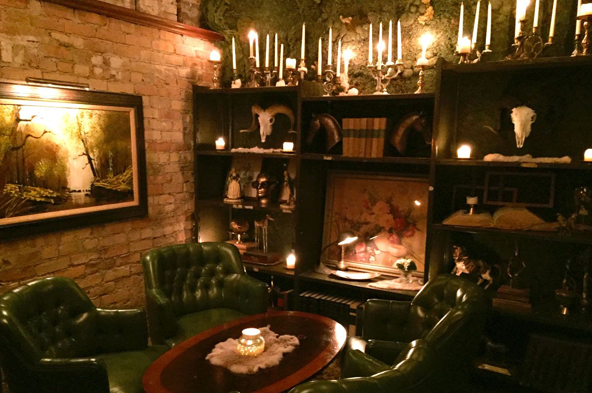Interior of The Rest, an intimate speakeasy-style bar in downtown Salt Lake City featuring moody lighting and vintage decor