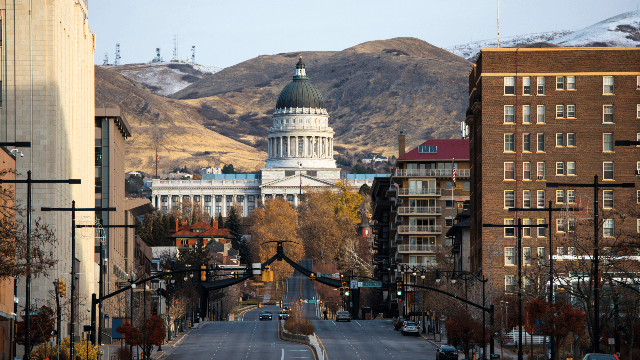 Street view of downtown Salt Lake City with the Utah State Capitol and mountains in the background