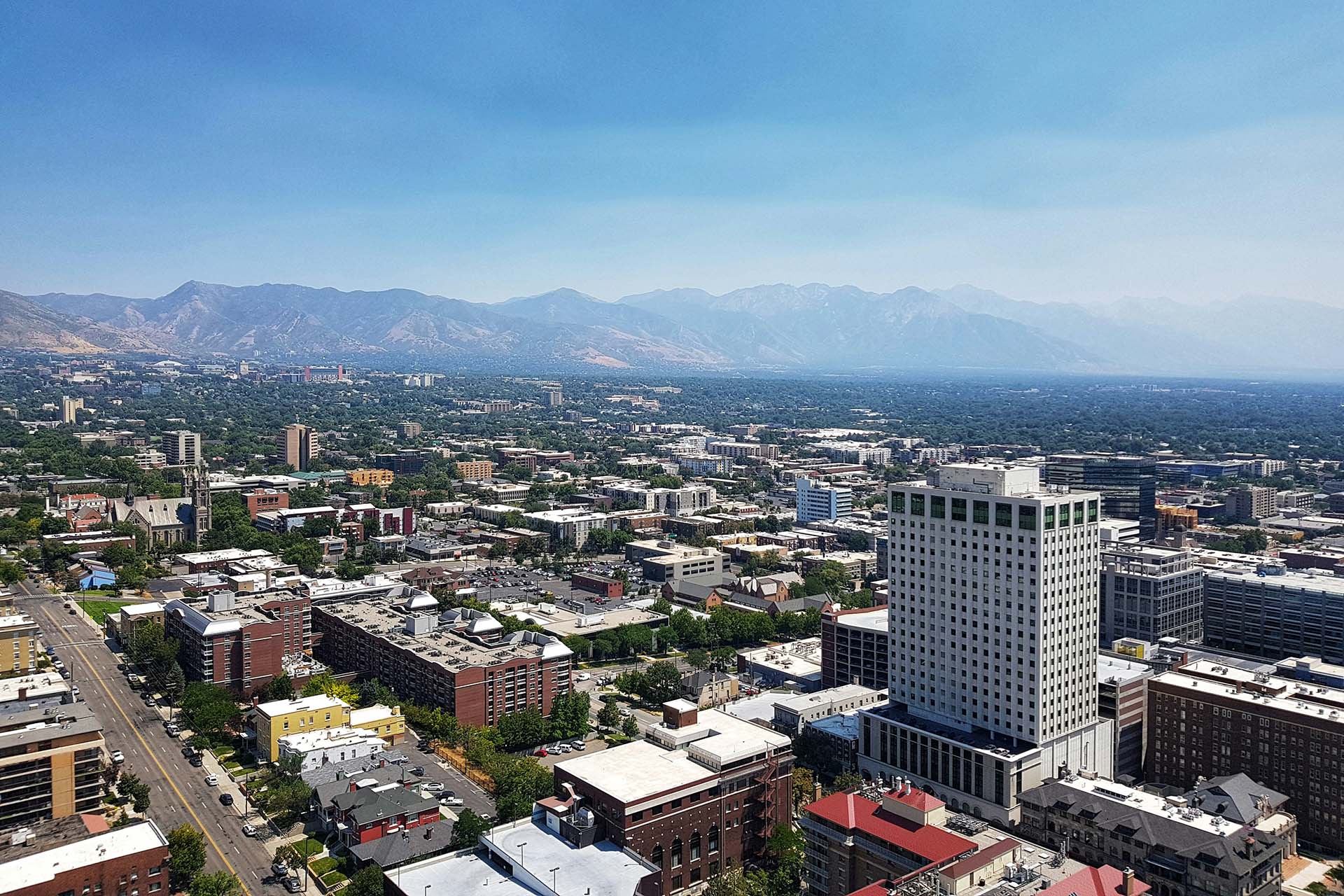Aerial view of the Salt Lake City skyline and distant mountains.
