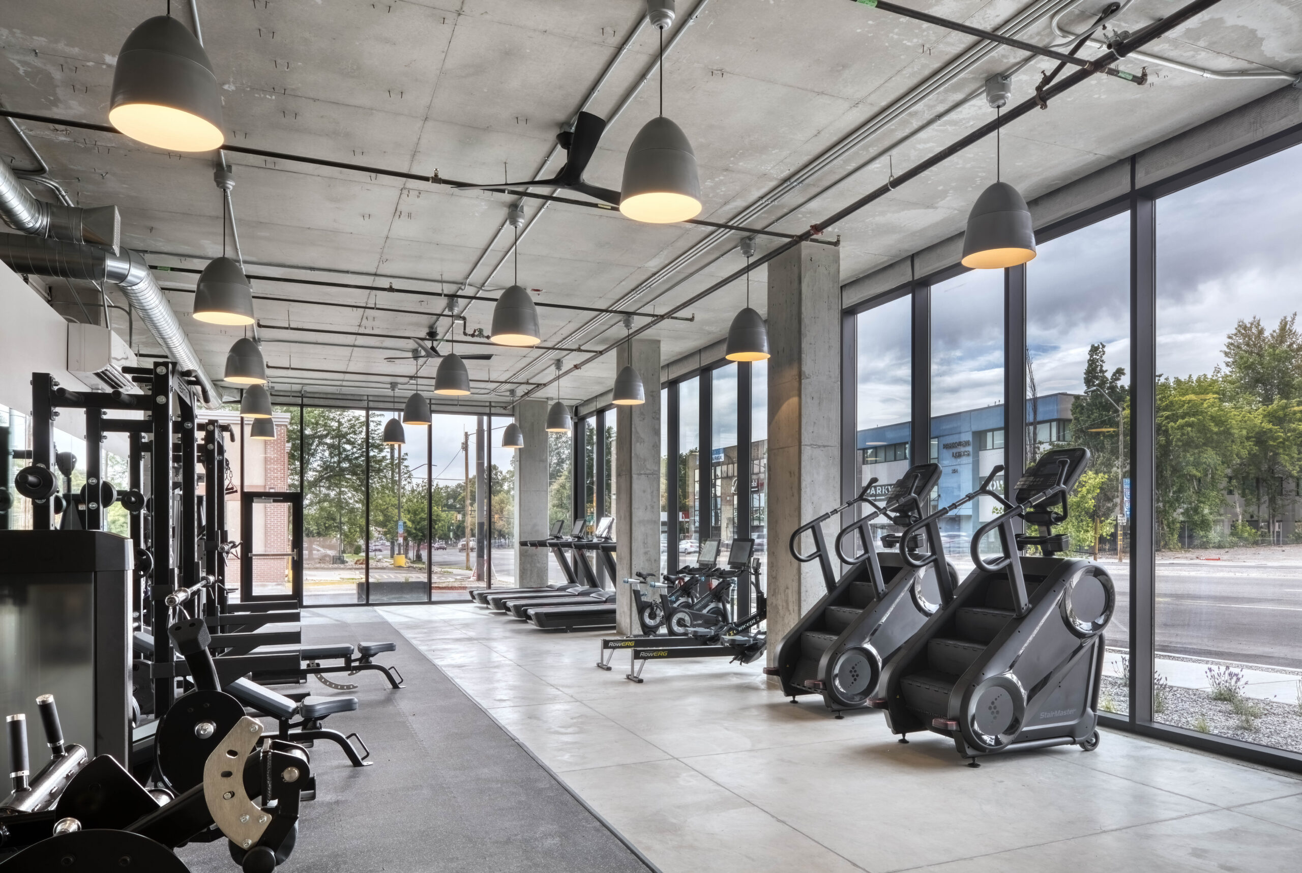 gym facilities with cement ceilings and overhead lights