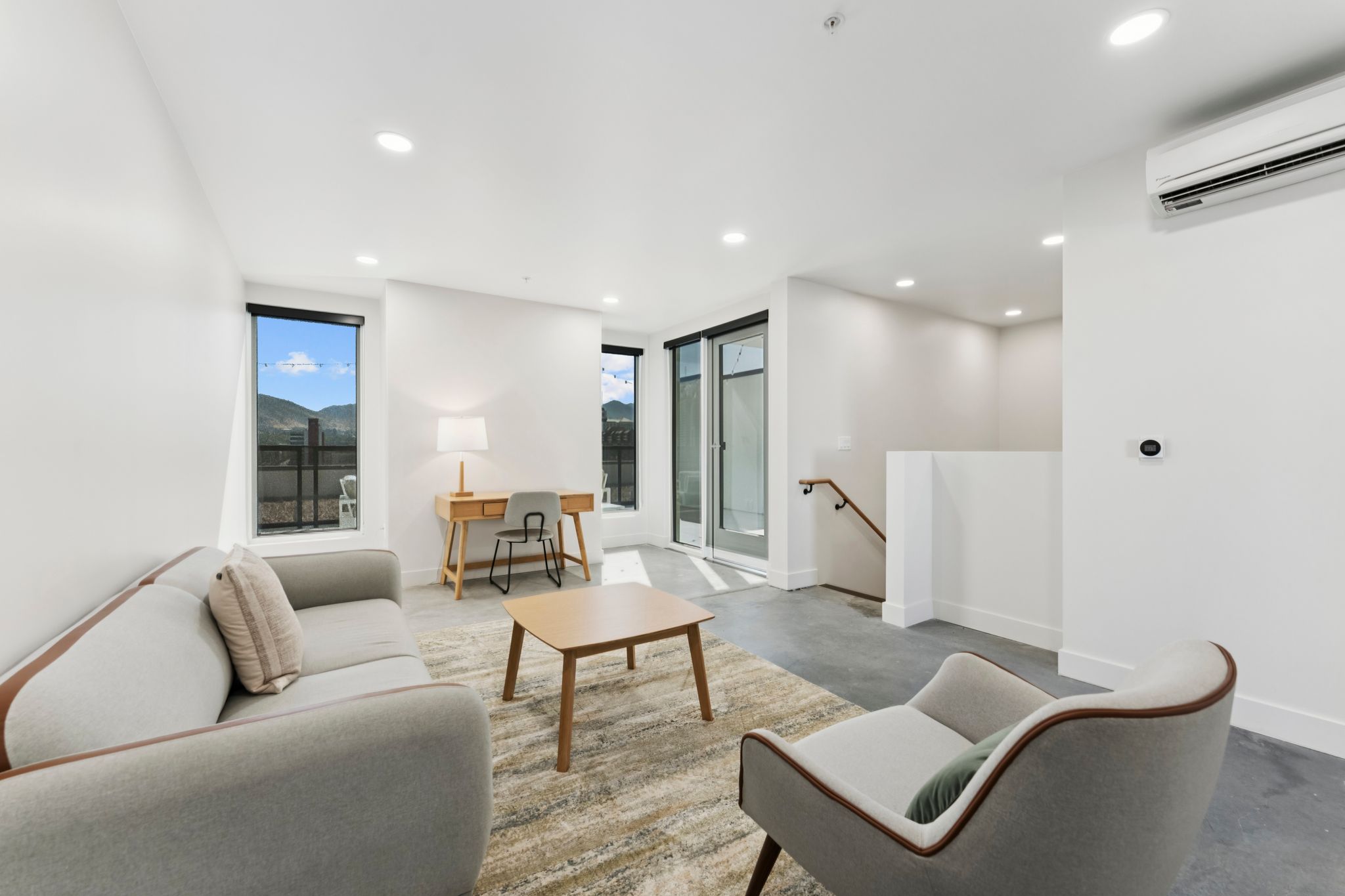 Large living area with floor to ceiling windows in luxury apartment in Salt Lake City