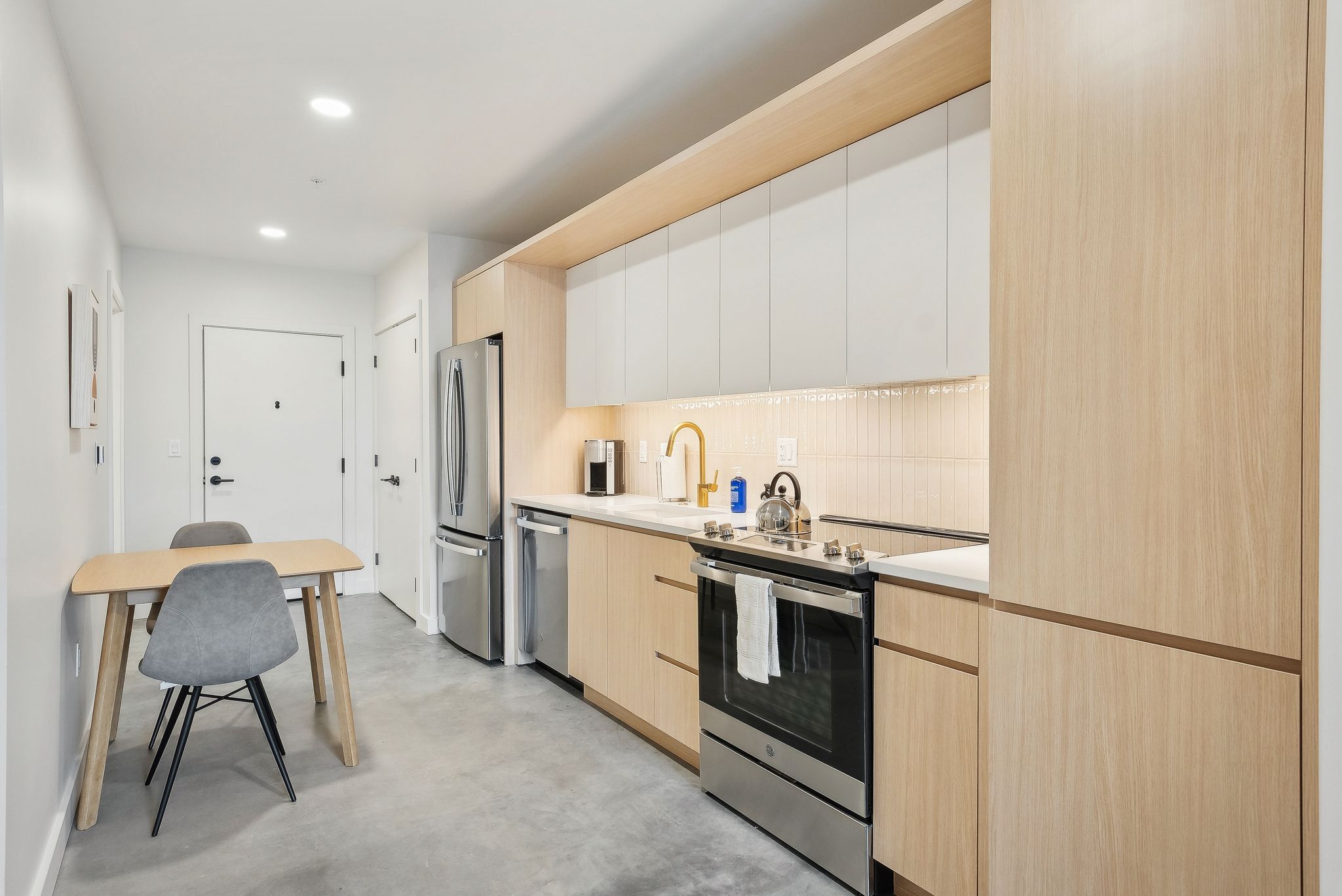Full kitchen with stainless steel appliances in studio apartment in Salt Lake City