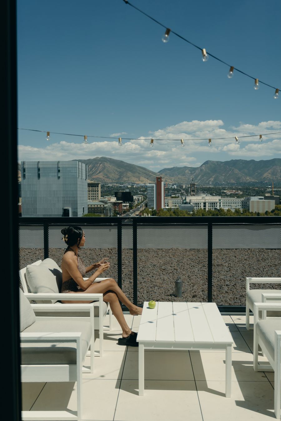 Woman enjoying mountain view on private balcony in SLC